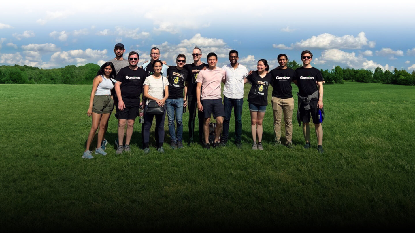 A few of the team members at Gordian standing in a field.